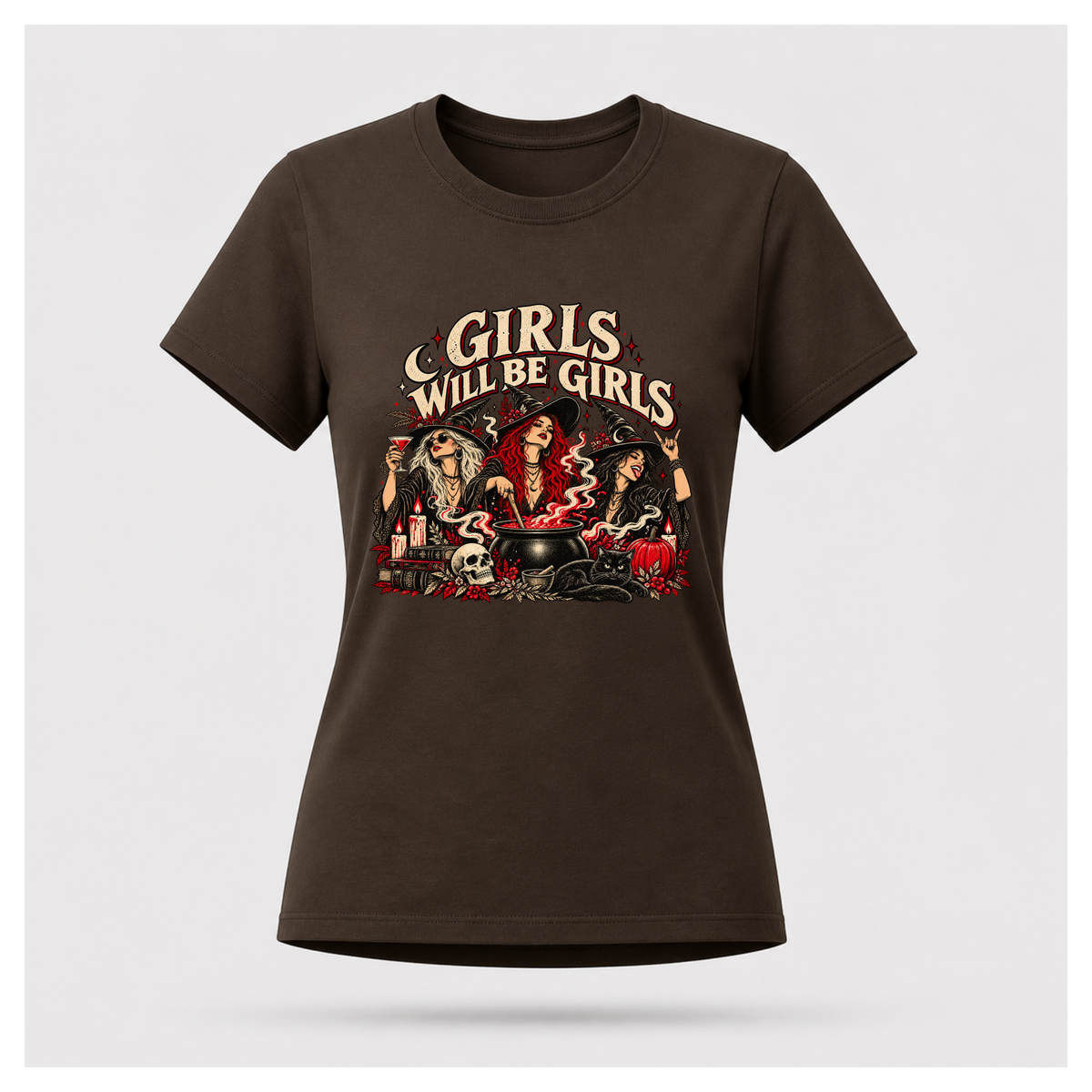 Girls Will Be Girls Tee in dark chocolate, floating female T-shirt mockup with three witches, a black cat, cauldron and bold vintage cream lettering.