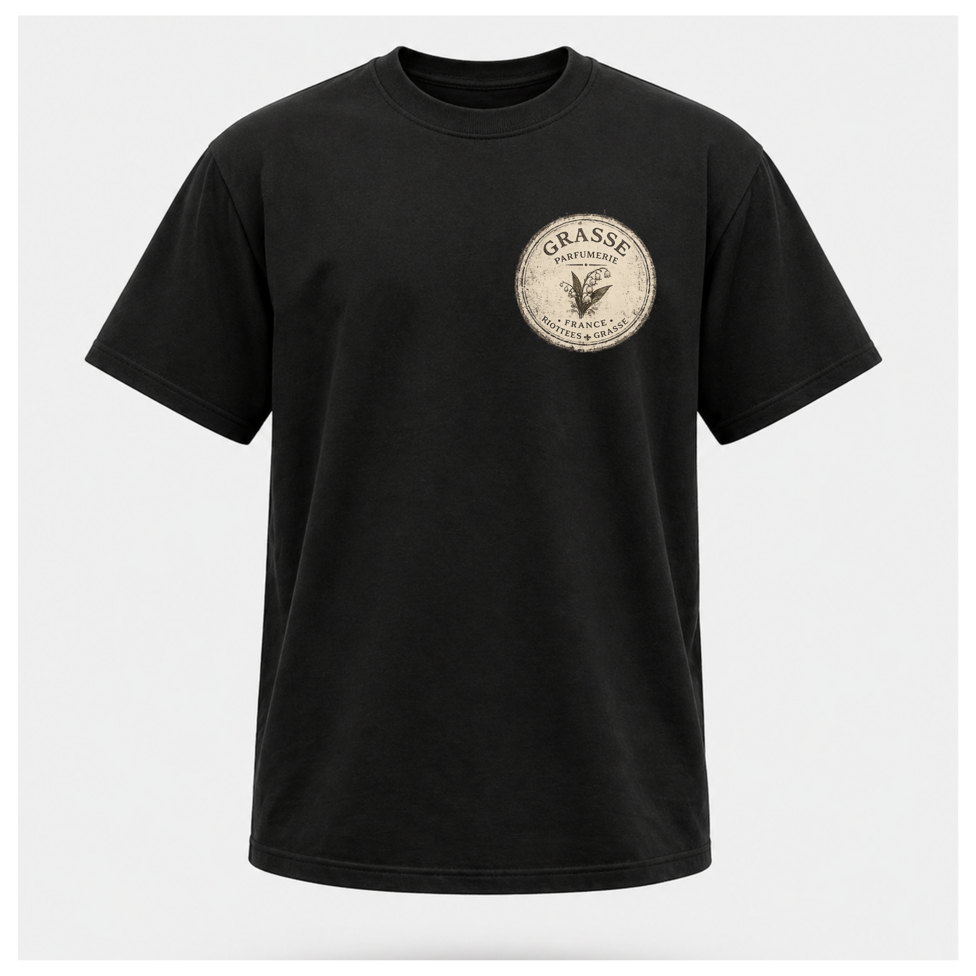 Black Grasse Parfum Apothecary T-shirt on a floating male form, featuring the small vintage apothecary emblem front design by RIOTTEES.