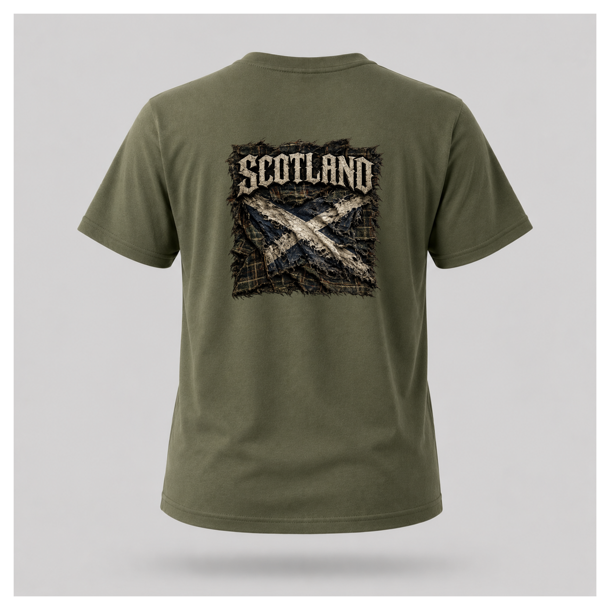 Male model wearing a military green Gildan 5000 t-shirt featuring the Modern Scotland design on the back, displaying distressed Scotland lettering above a weathered Saltire over tartan, by RIOTTEES.