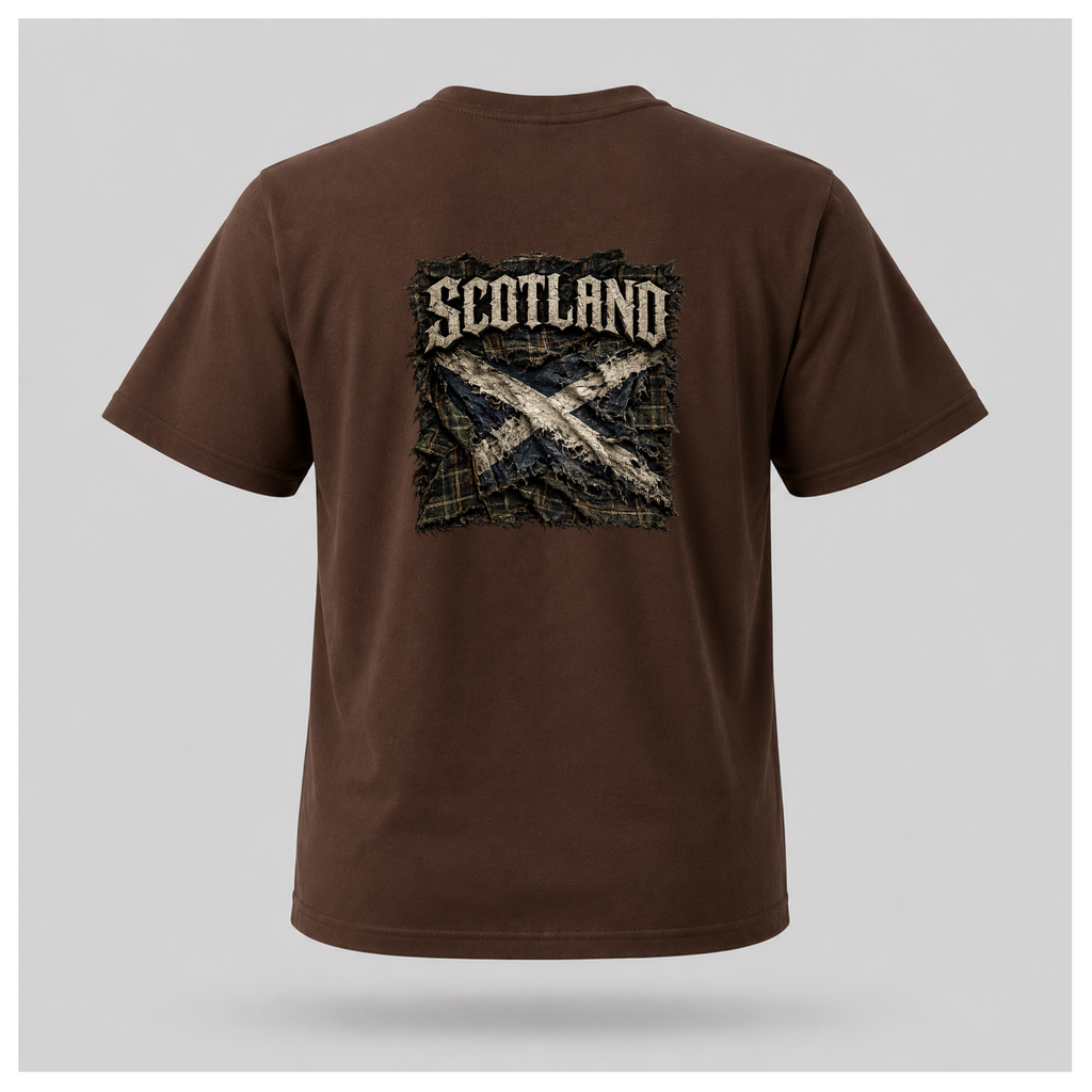 Male model wearing a chocolate brown Gildan 5000 t-shirt featuring the Modern Scotland design on the back, highlighting distressed Scotland lettering above a weathered Saltire layered over tartan, by RIOTTEES.