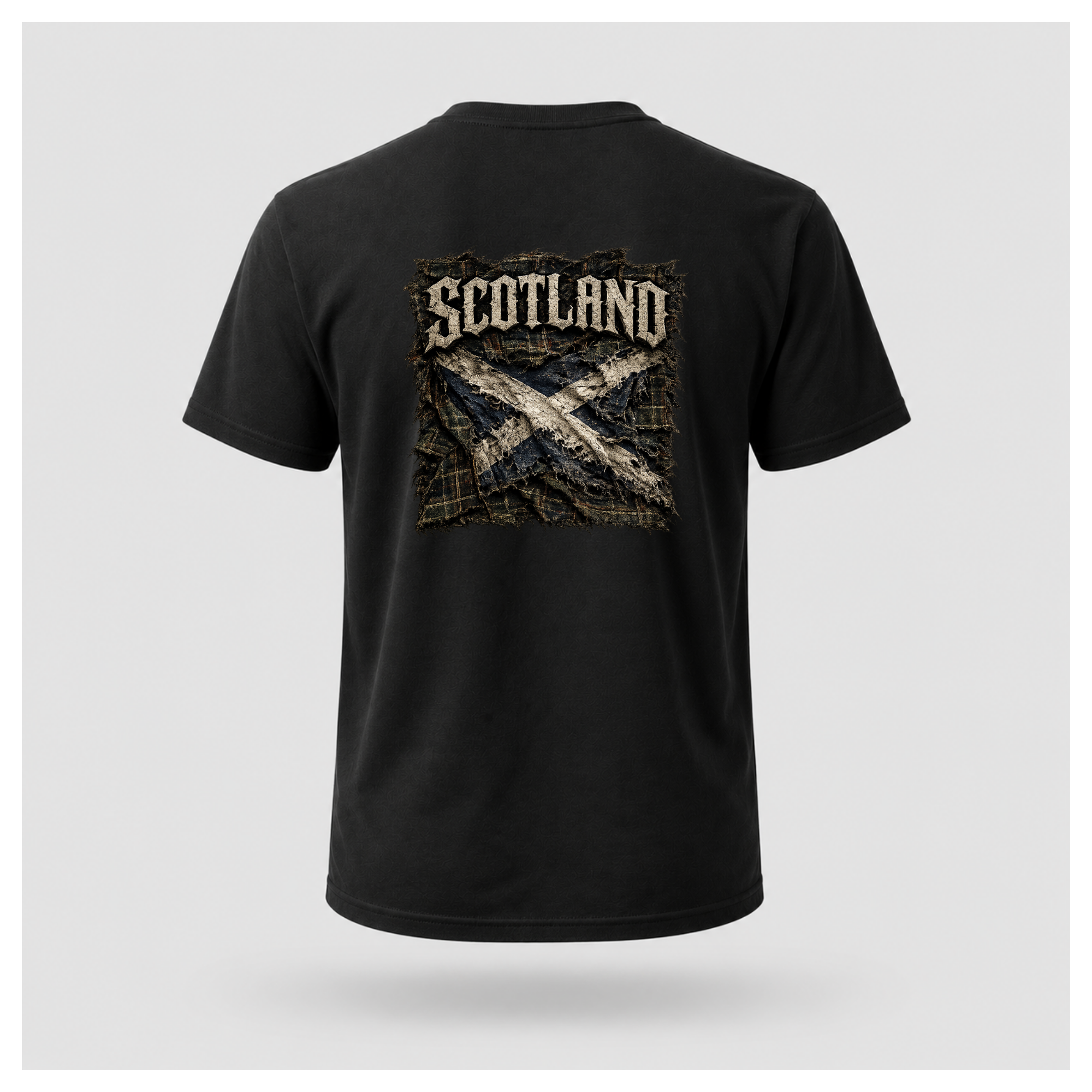 Male model wearing a black Gildan 5000 t-shirt featuring the Modern Scotland design on the back, displaying distressed Scotland lettering above a weathered Saltire layered over tartan, by RIOTTEES.