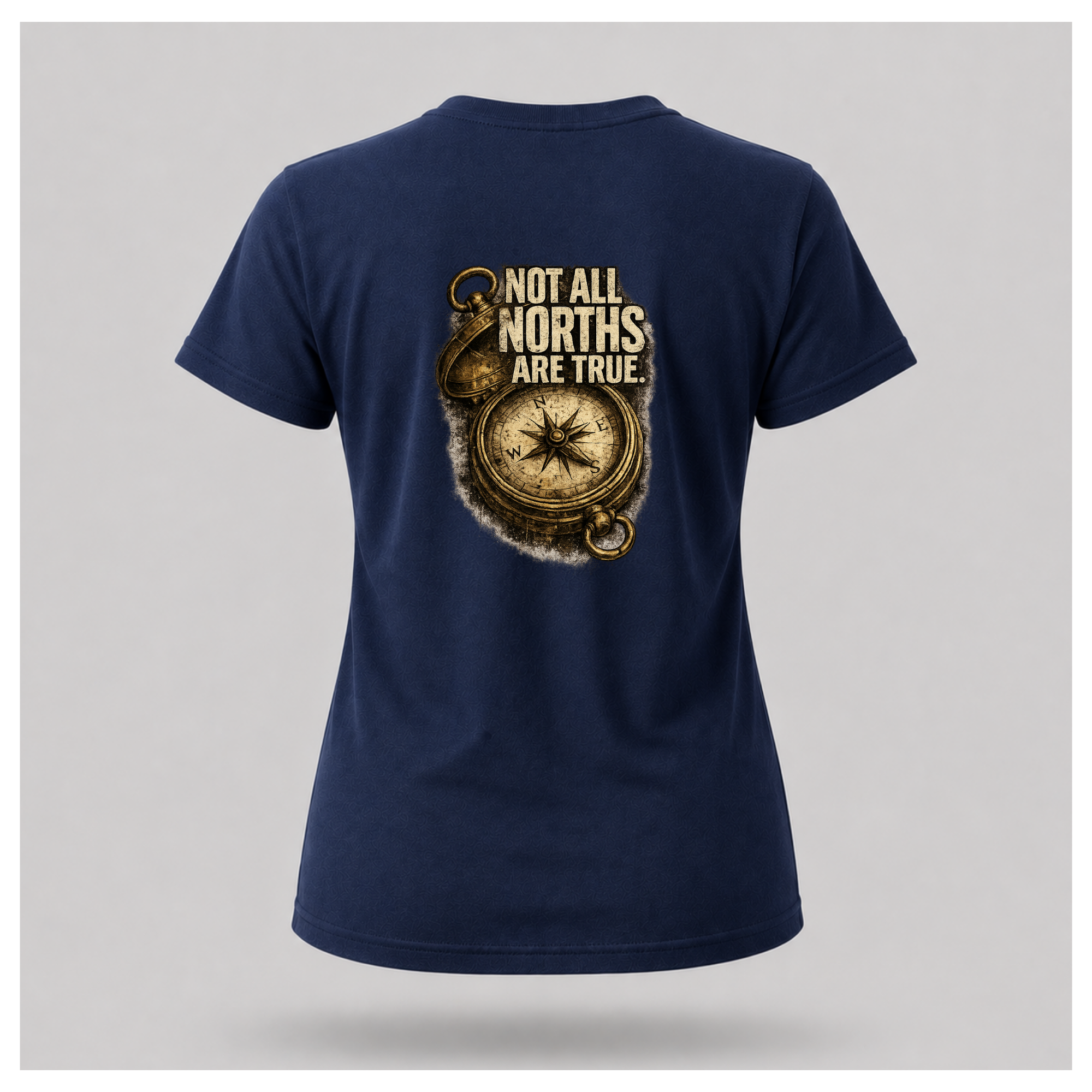 Floating female form wearing the back of the Not All Norths Are True T-shirt in Navy Blue, featuring distressed "NOT ALL NORTHS ARE TRUE" text over a vintage compass graphic by RIOTTEES.