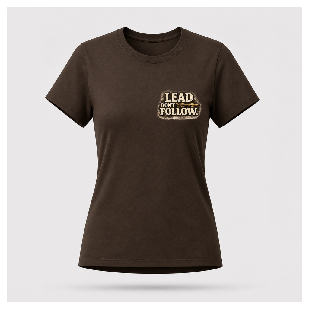 Floating female form wearing the front of the Not All Norths Are True T-shirt in Chocolate Brown, featuring distressed "LEAD DON'T FOLLOW" typography with a vintage arrow by RIOTTEES.