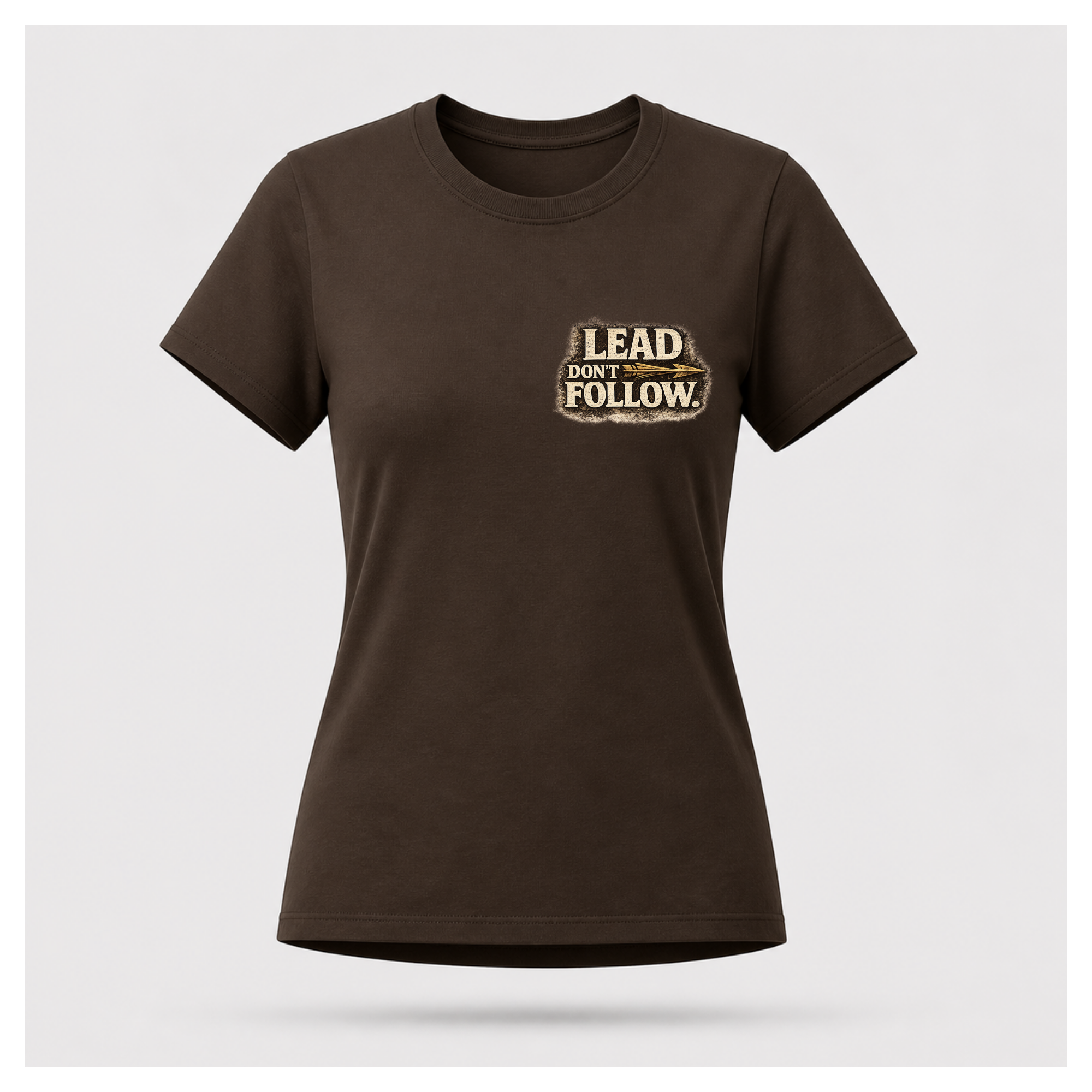 Floating female form wearing the front of the Not All Norths Are True T-shirt in Chocolate Brown, featuring distressed "LEAD DON'T FOLLOW" typography with a vintage arrow by RIOTTEES.