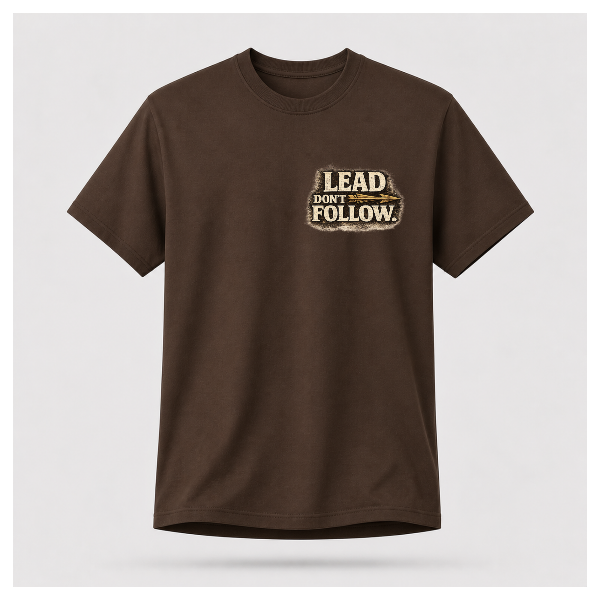 Floating male form wearing the front of the Not All Norths Are True T-shirt in Chocolate Brown, featuring distressed "LEAD DON'T FOLLOW" typography with a vintage arrow by RIOTTEES.