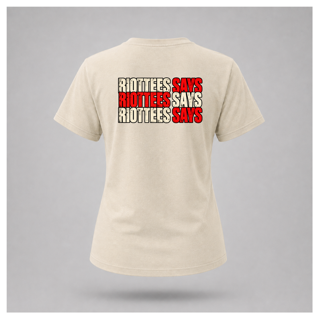 Women's sand RIOTTEES T-shirt featuring repeated RIOTTEES SAYS typography across the upper back in distressed red and off-white.