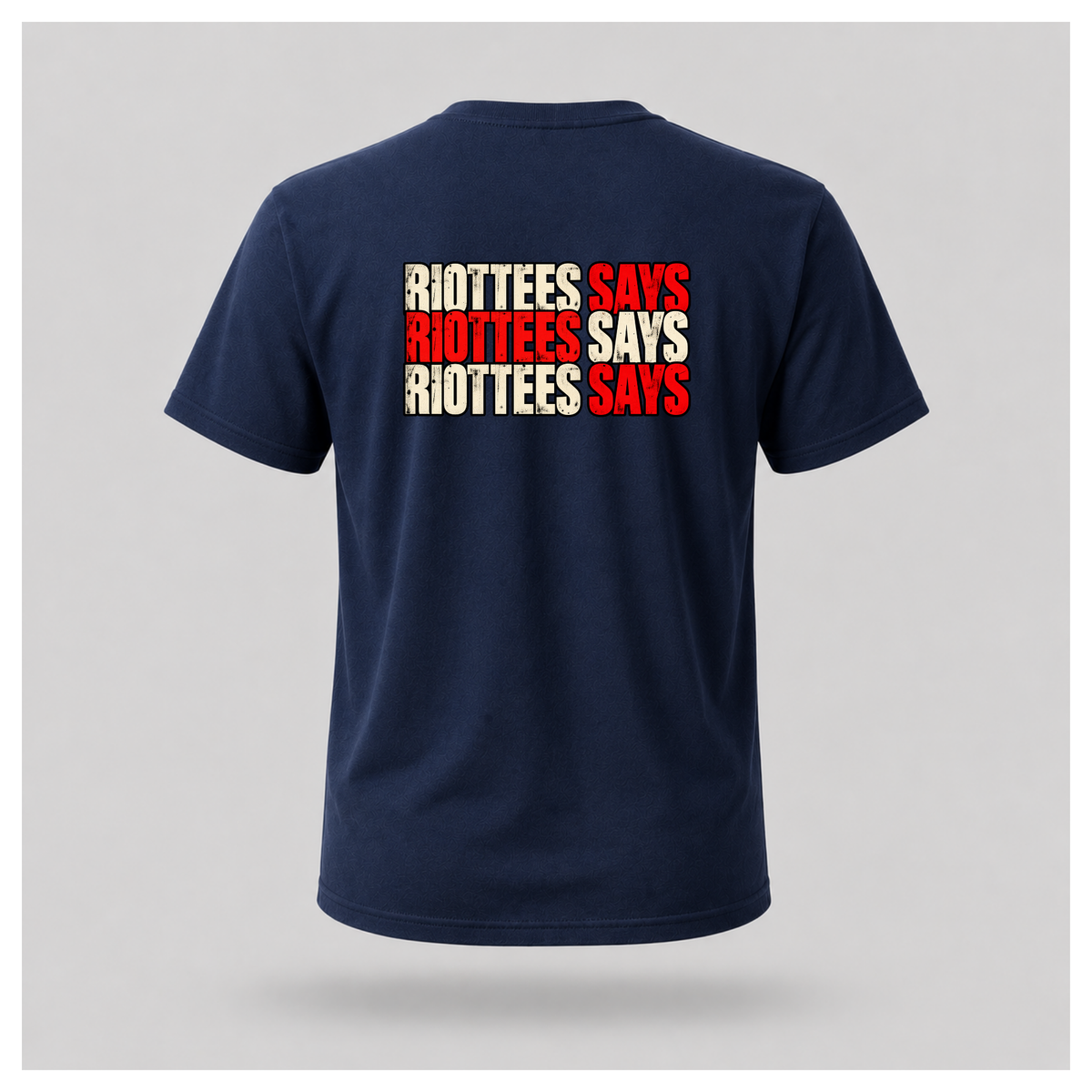 Men's navy blue RIOTTEES T-shirt featuring a bold three-line RIOTTEES SAYS back design in distressed red and off-white typography.