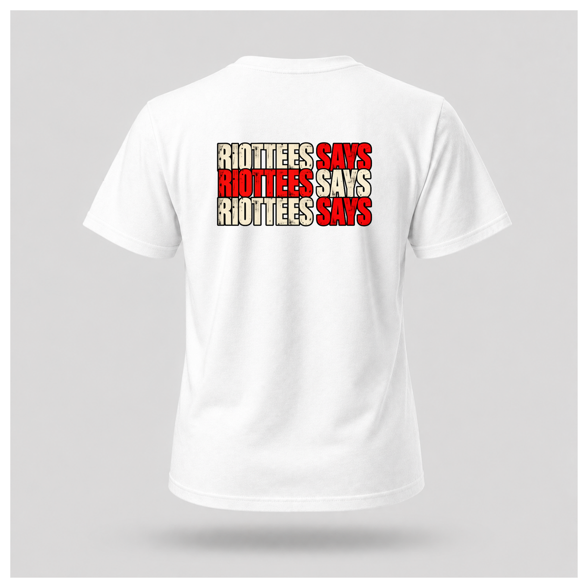 Men's white RIOTTEES T-shirt featuring a bold three-line RIOTTEES SAYS design in distressed red and off-white lettering with black outlines.