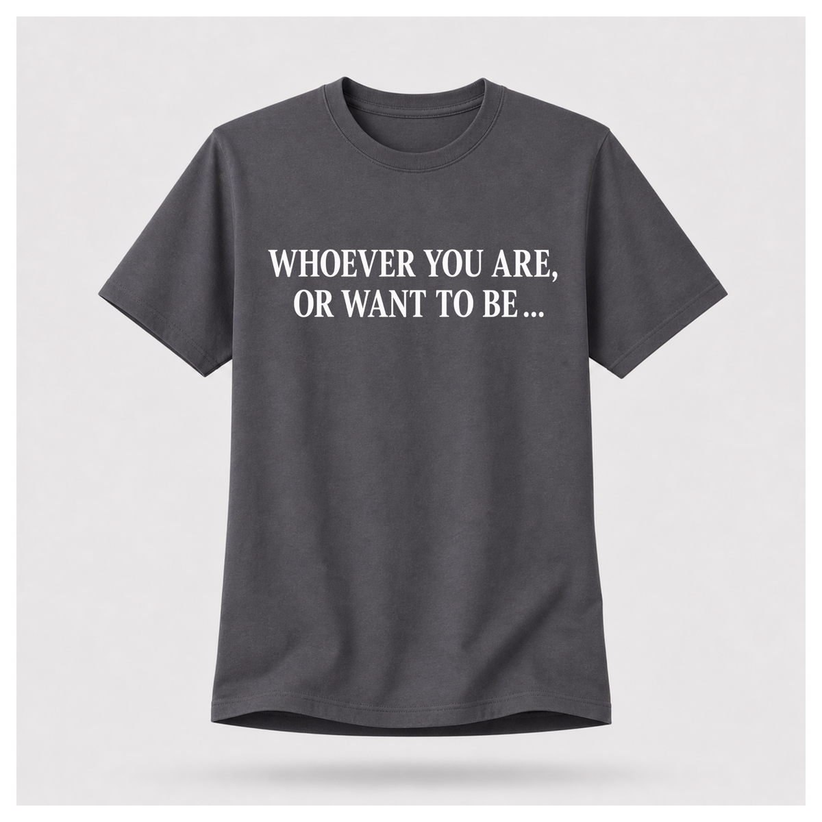 Male model wearing a charcoal grey Politics Is Interested In You T-shirt with “Whoever you are, or want to be...” printed in distressed white text on the front.