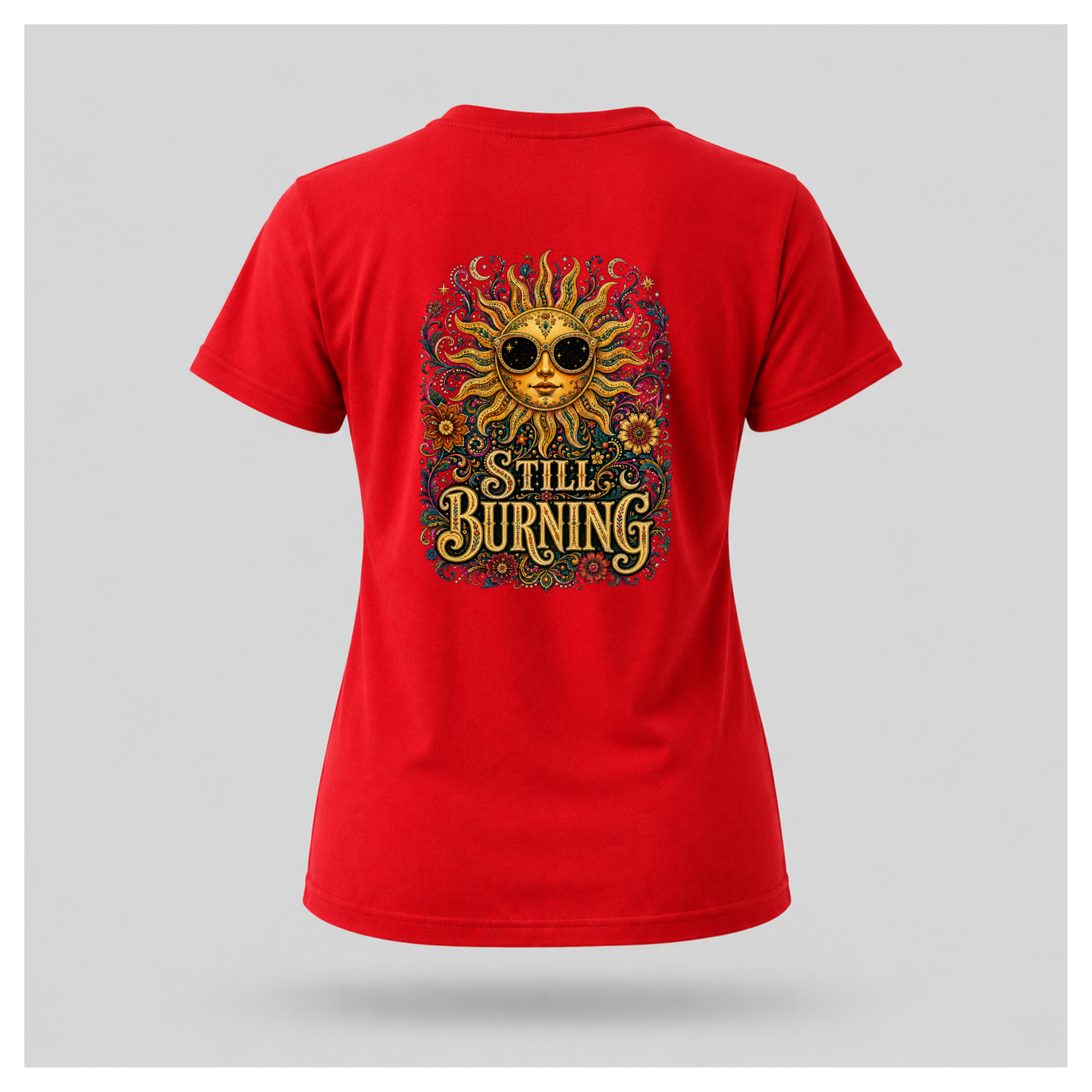 Back of a floating female form wearing the Red Still Burning Sun Spirit Tee featuring an ornate celestial sun with floral artwork and the words "Still Burning" by RIOTTEES.