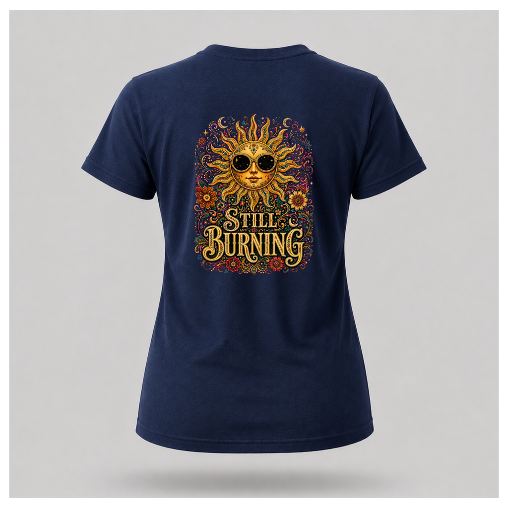 Back of a floating female form wearing the Navy Blue Still Burning Sun Spirit Tee featuring an ornate celestial sun with floral artwork and the words "Still Burning" by RIOTTEES.