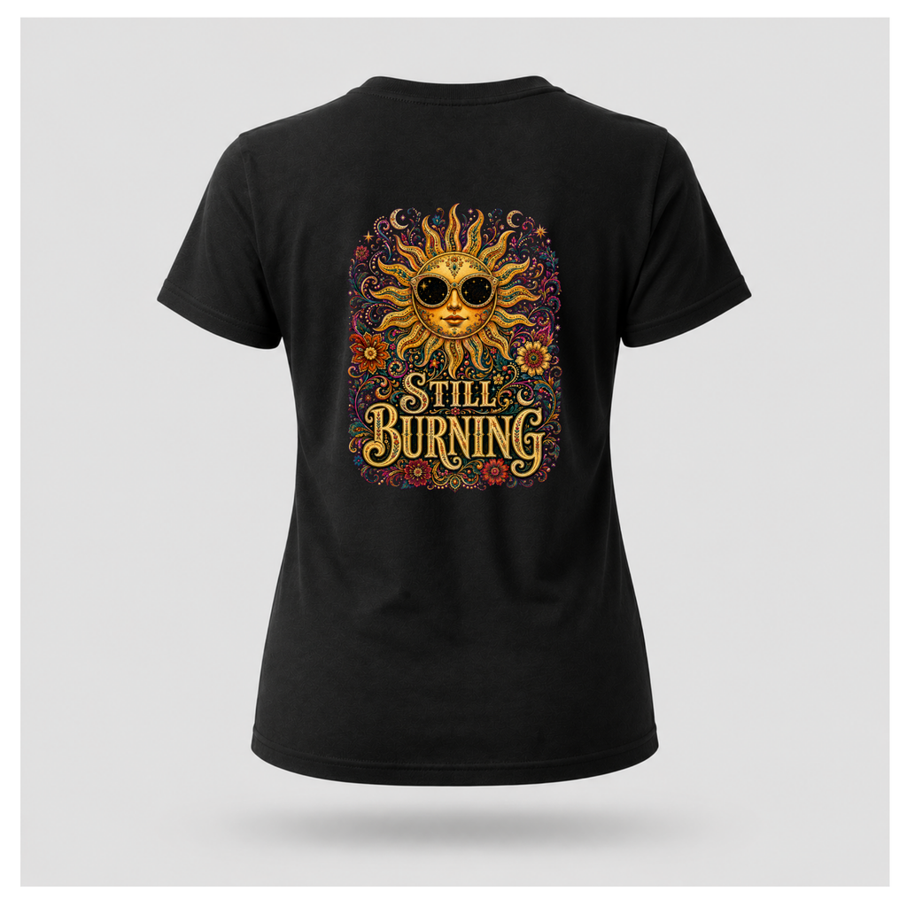 Back of a floating female form wearing the Black Still Burning Sun Spirit Tee featuring an ornate celestial sun with floral artwork and the words "Still Burning" by RIOTTEES.