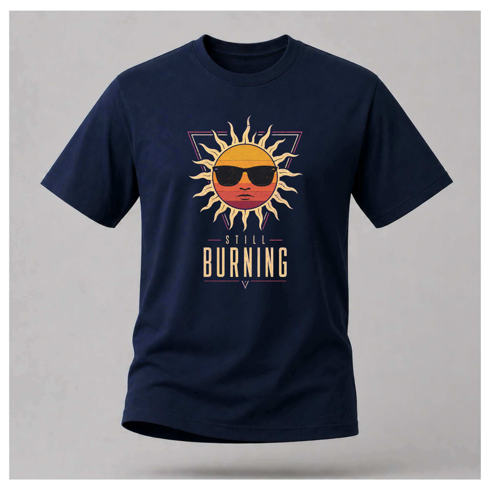 Floating male form wearing the Navy Blue Still Burning Sunset Prism Gildan 5000 T-shirt featuring the vintage sunset face wearing sunglasses graphic with Still Burning typography by RIOTTEES.