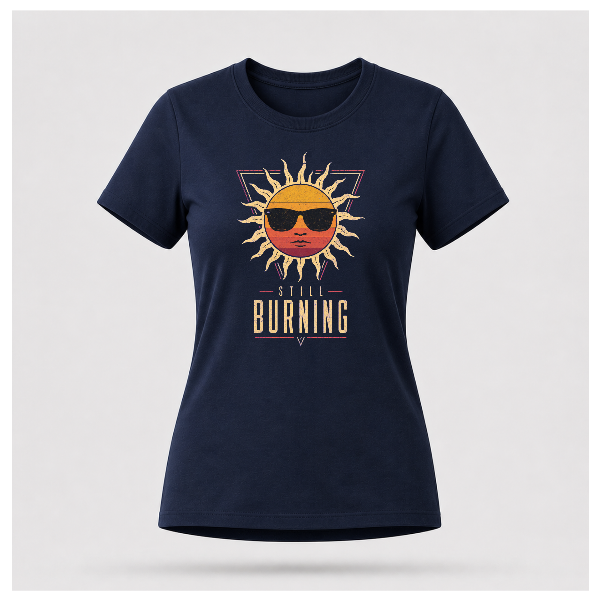 Floating female form wearing the Navy Blue Still Burning Sunset Prism Gildan 5000 T-shirt featuring the vintage sunset face wearing sunglasses graphic with Still Burning typography by RIOTTEES.