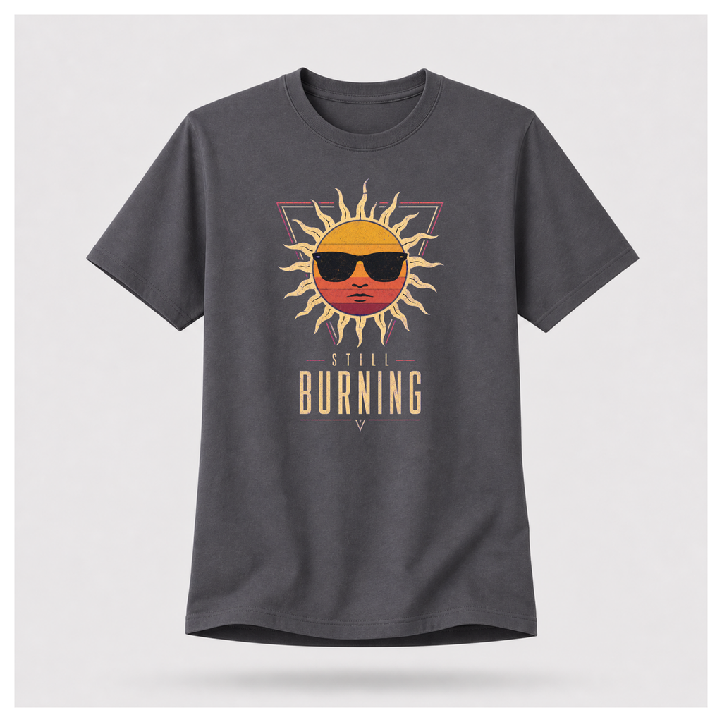 Floating male form wearing the Charcoal Grey Still Burning Sunset Prism Gildan 5000 T-shirt featuring the vintage sunset face wearing sunglasses graphic with Still Burning typography by RIOTTEES.