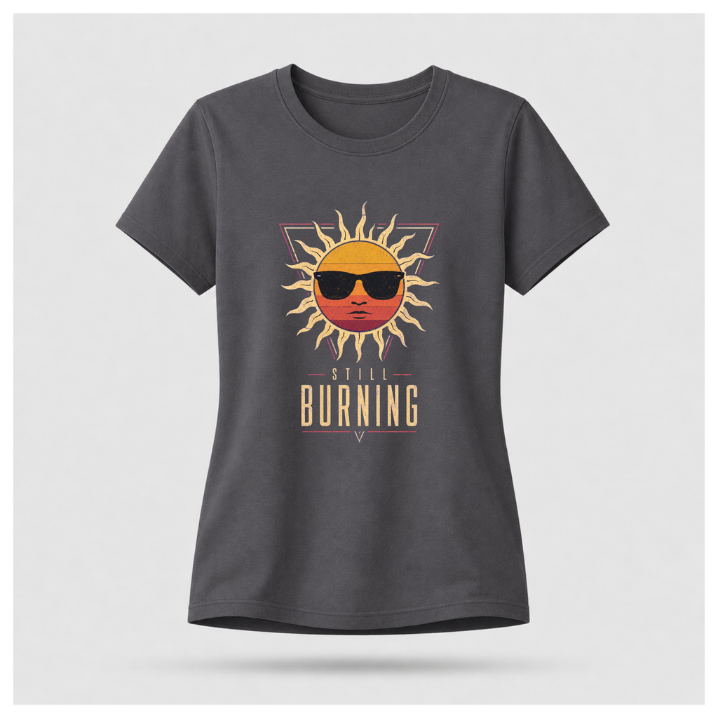 Floating female form wearing the Charcoal Grey Still Burning Sunset Prism Gildan 5000 T-shirt featuring the vintage sunset face wearing sunglasses graphic with Still Burning typography by RIOTTEES.