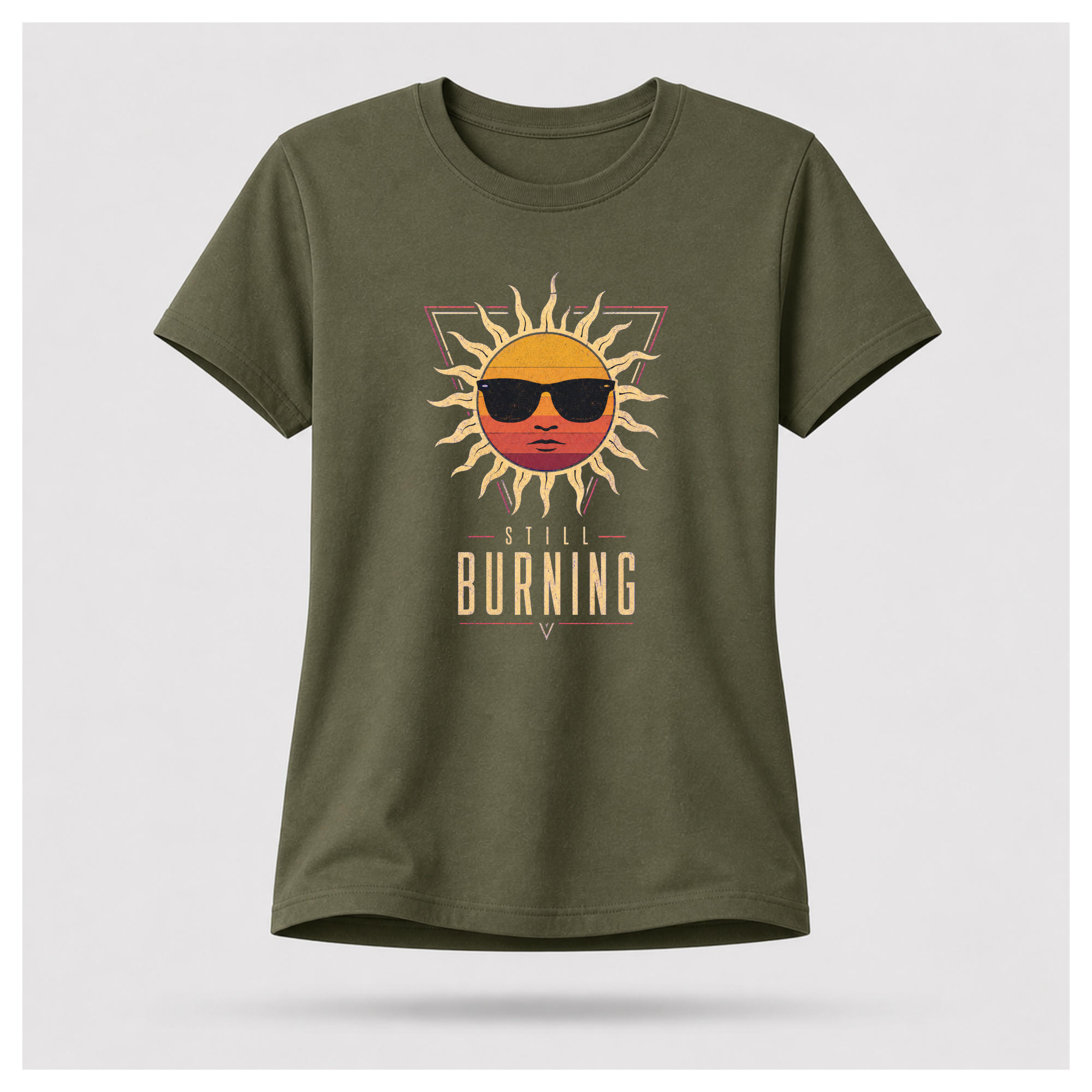 Floating female form wearing the Military Green Still Burning Sunset Prism Gildan 5000 T-shirt featuring the vintage sunset face wearing sunglasses graphic with Still Burning typography by RIOTTEES.