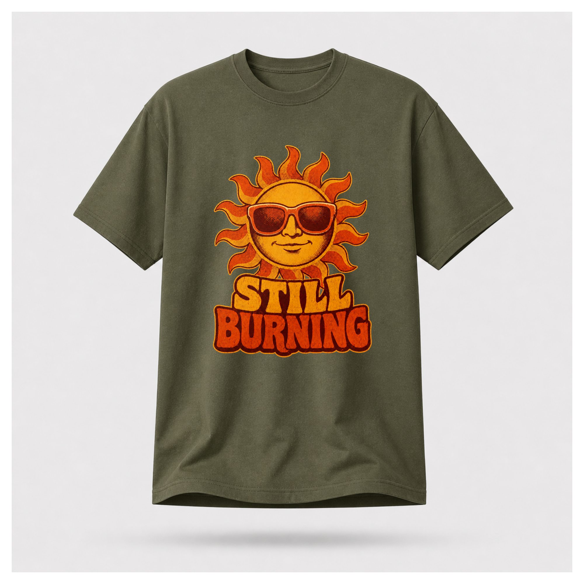 Military Green Still Burning Vintage Tee shown from the front on a floating male form with the Still Burning vintage sun artwork clearly visible, by RIOTTEES.