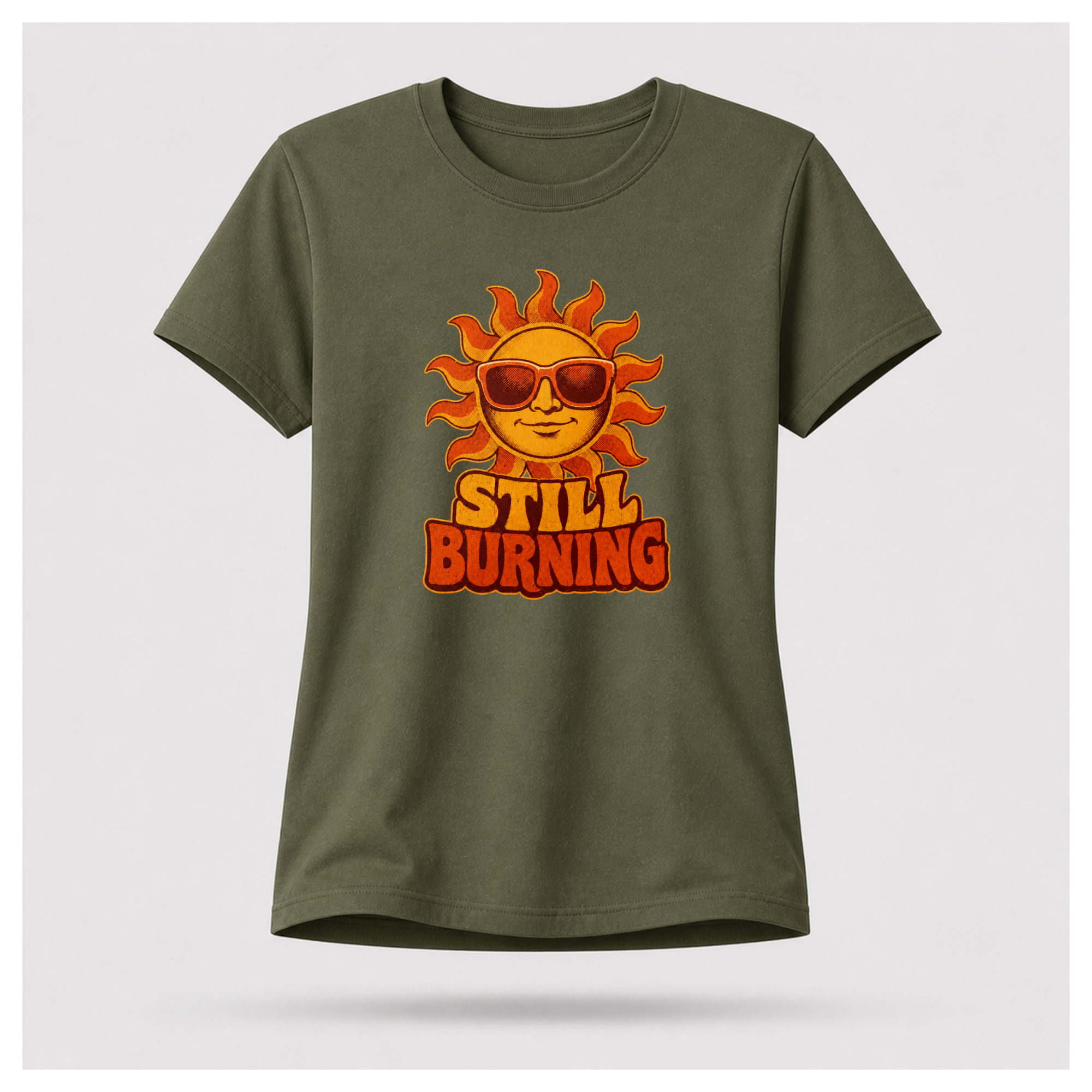 Military Green Still Burning Vintage Tee shown from the front on a floating female form with the Still Burning vintage sun artwork clearly visible, by RIOTTEES.