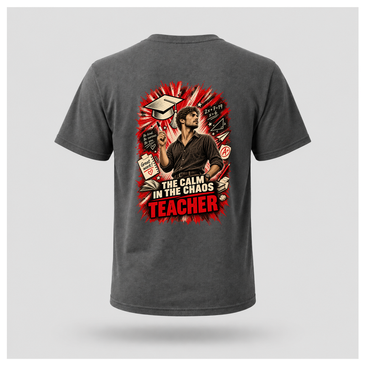Charcoal grey male floating-form T-shirt featuring the large Teacher — Calm in the Chaos back graphic with a male teacher surrounded by illustrated classroom and education symbols.