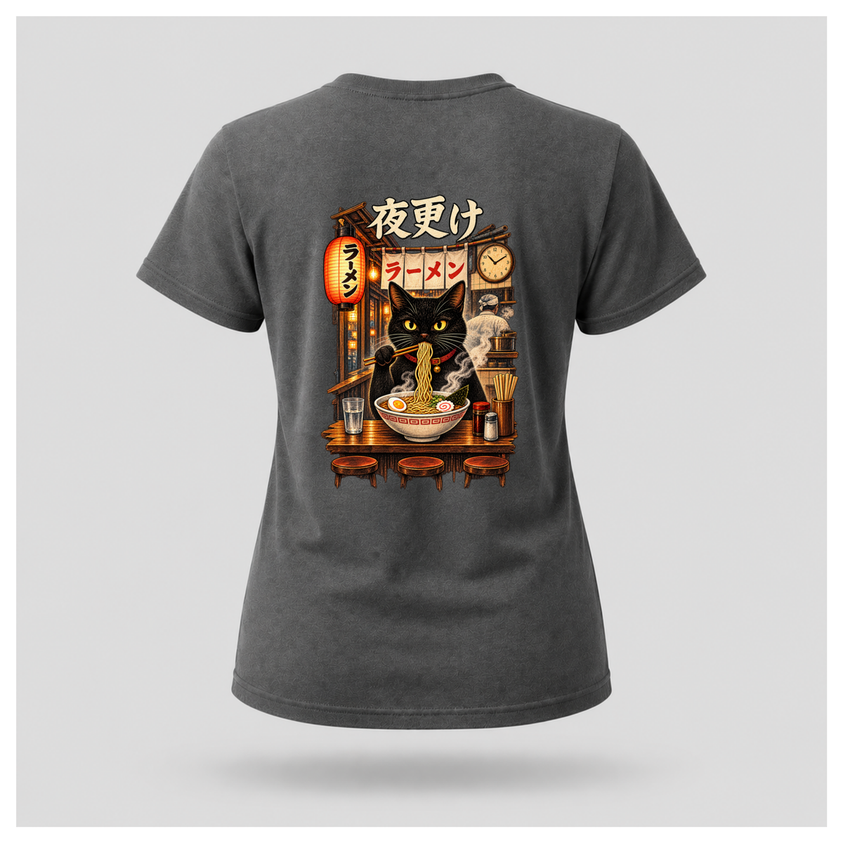 Female floating form wearing a charcoal grey Yofuke Ramen Cat graphic T-shirt, showing the large Japanese-inspired ramen cat back design by RIOTTEES.