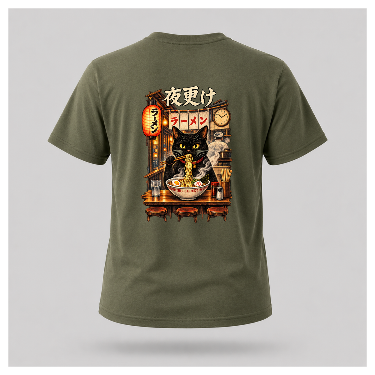 Male floating form wearing a military green Yofuke Ramen Cat graphic T-shirt, showing the large Japanese-inspired ramen cat back design by RIOTTEES.